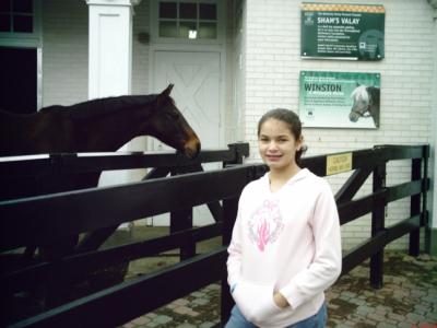 Hannah with a race horse in Kentucky